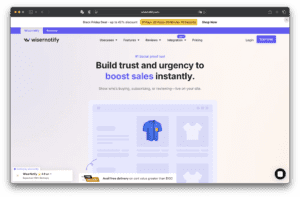 The homepage of Wisernotify's website displays a headline on building trust and improving sales, a navigation menu at the top, a blue shirt product image, and an online store graphic.